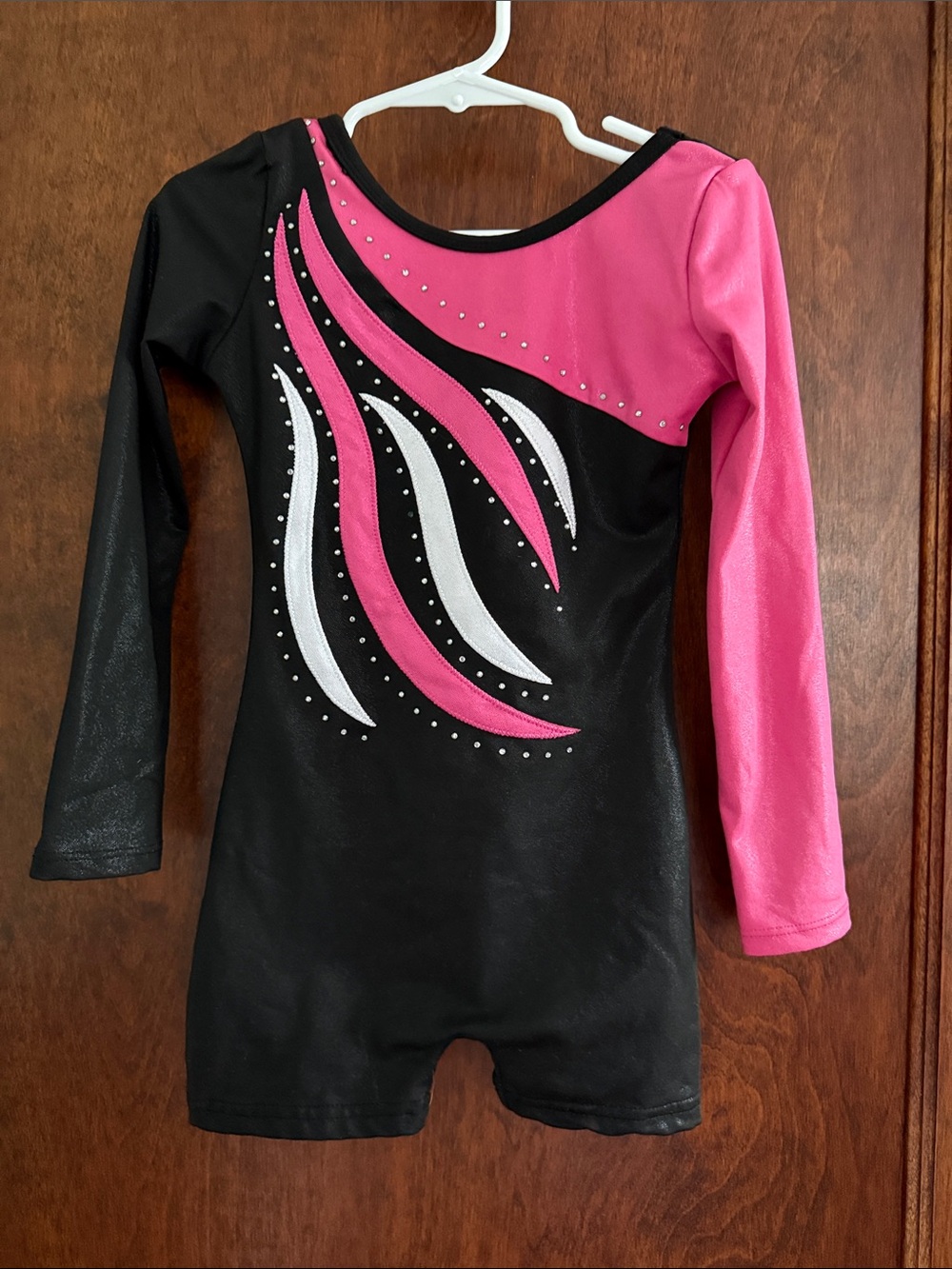 Pink, black, and white gymnastics leotard